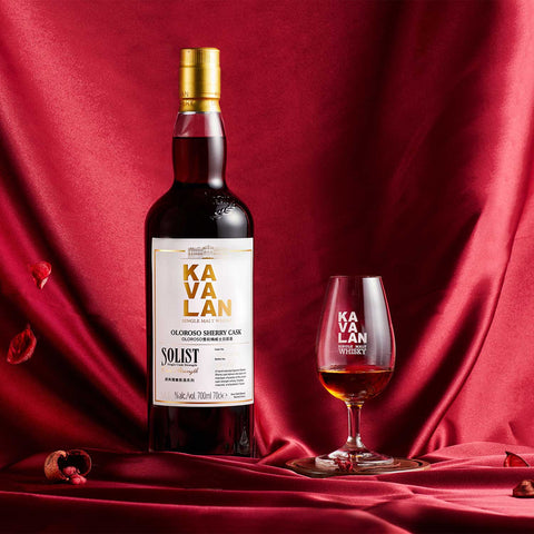 Kavalan Solist Oloroso Sherry Cask on red silk with a nosing glass