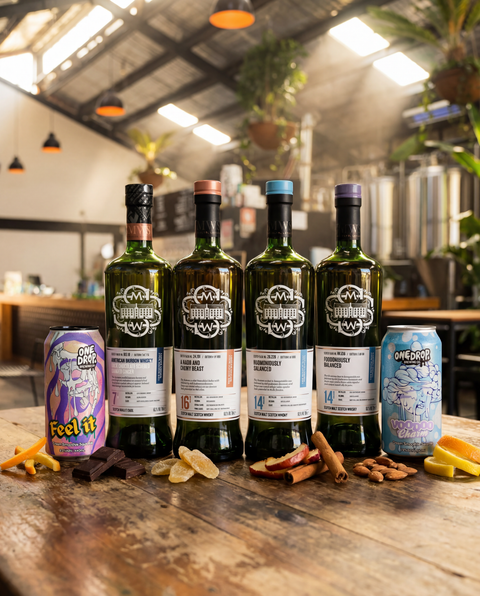 Four SMWS bottles and One Drop beer bottles arranged on dark surface.