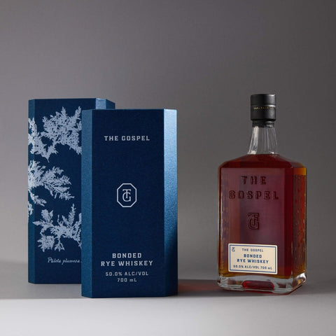 The Gospel Bonded Rye Whiskey bottle beside its cyanotype gift box